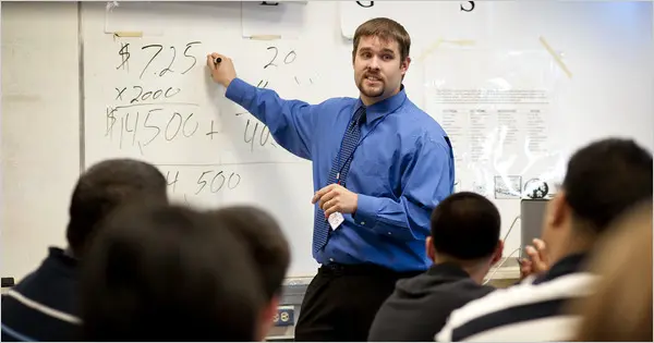 Teacher leading financial education class